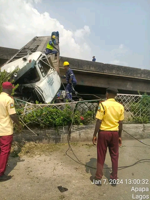 JUST-IN: Truck Falls Off Lagos High Bridge As LASTMA Rescue Injured Driver, Other